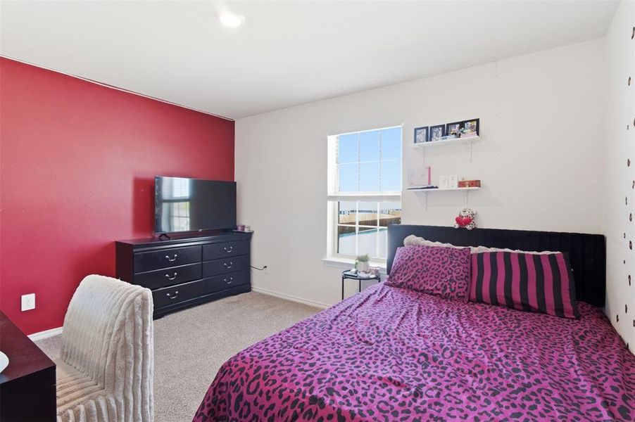 Bedroom featuring light colored carpet and baseboards Bedroom featuring light colored carpet and baseboards