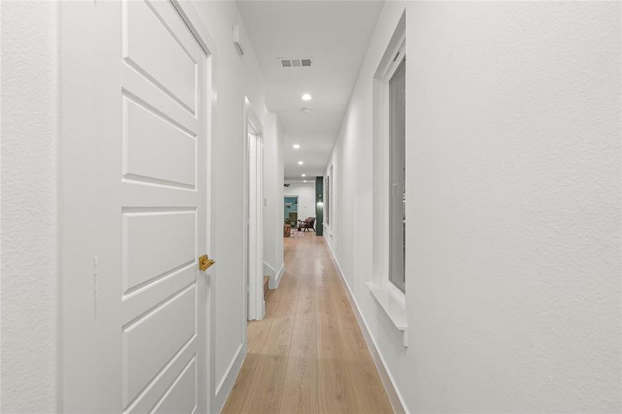 Hallway featuring light wood-style flooring and recessed lighting
