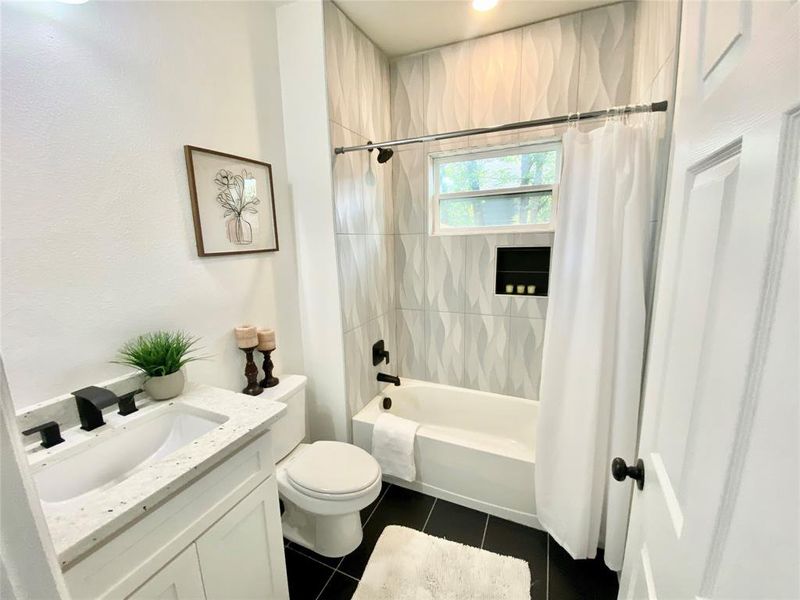 Full bathroom featuring tile patterned flooring, shower / bathtub combination with curtain, toilet, and vanity