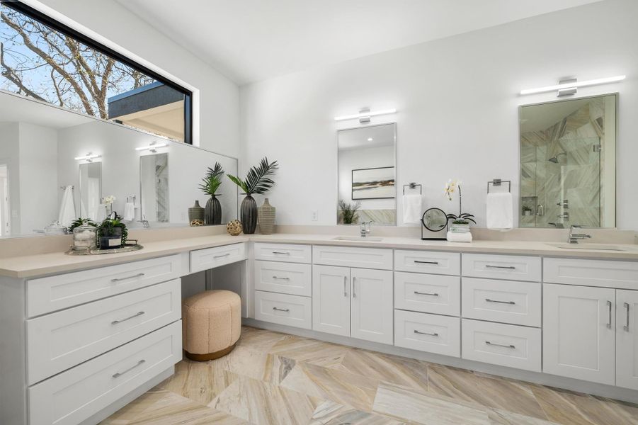 Bathroom with double vanity, a marble finish shower, and a sink