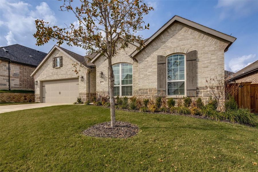 Front exterior of a new home in Reunion 60s, Rhome, TX, highlighting curb appeal (Image 20).