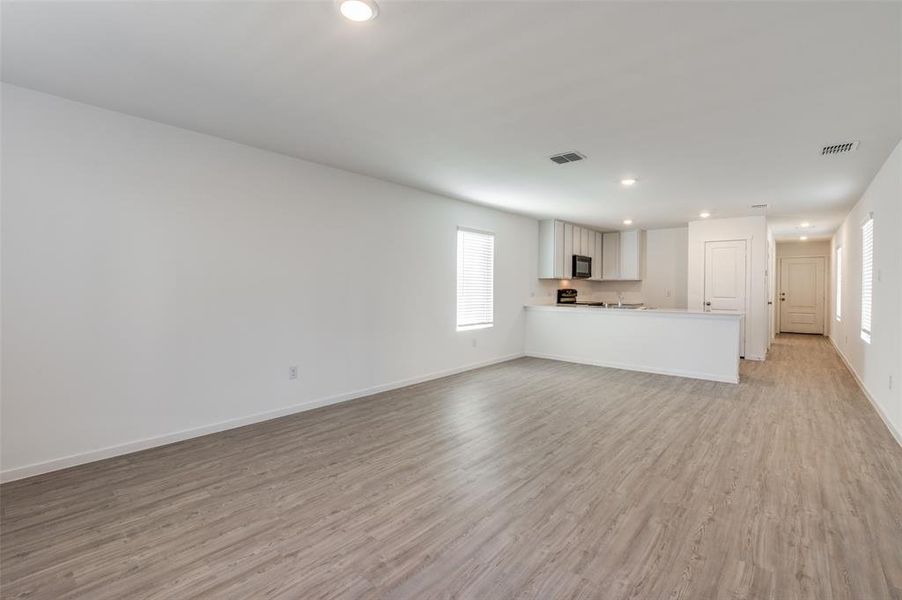 Unfurnished living room with light hardwood / wood-style flooring