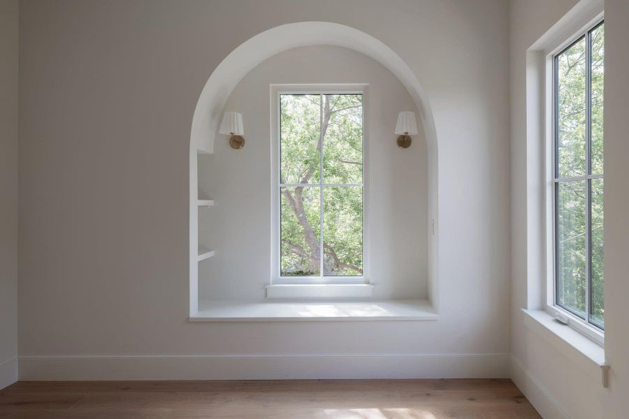 Architectural treatments include arched bench seating and built in shelves.