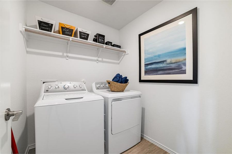 Laundry room with washer and clothes dryer and light wood finished floors Laundry room with washer and clothes dryer and light wood finished floors