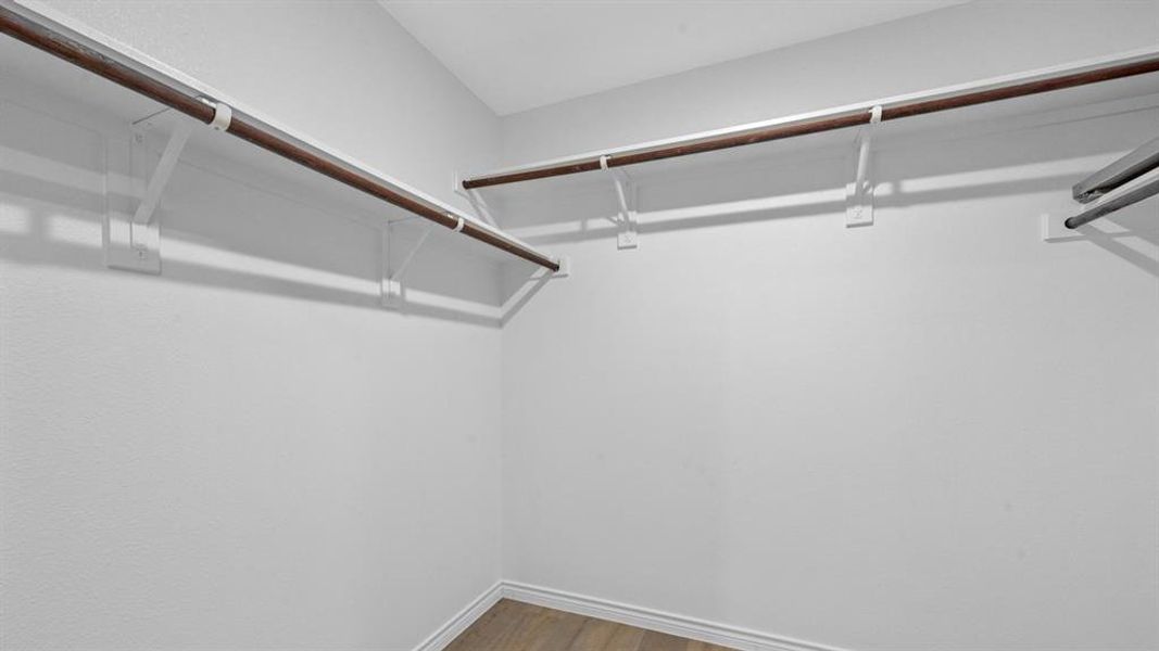 Walk in closet with light wood-type flooring Walk in closet with light wood-type flooring
