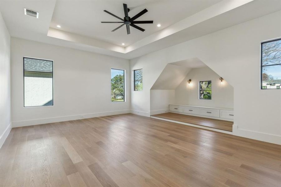 Additional living space with ceiling fan and light wood-type flooring