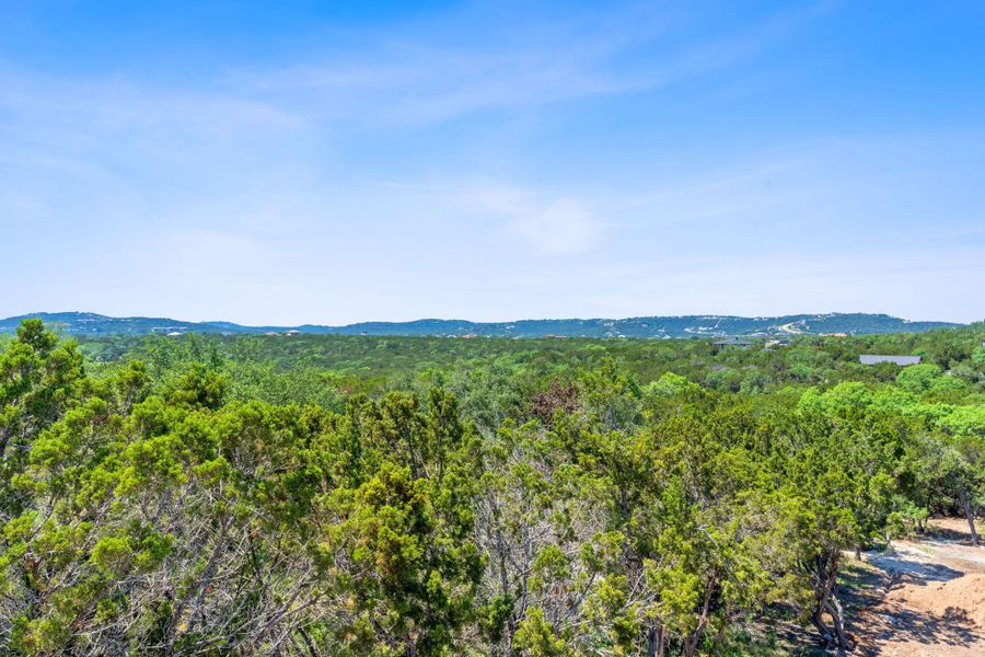 View of mountain backdrop featuring a forest View of mountain backdrop featuring a forest