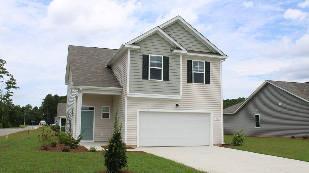 Front exterior of a new home in The Bluffs at Mill Creek, Florence, SC, highlighting curb appeal (Image 2). Front exterior of a new home in The Bluffs at Mill Creek, Florence, SC, highlighting curb appeal (Image 2).