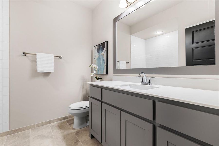 Bathroom with vanity, tile patterned flooring, and toilet