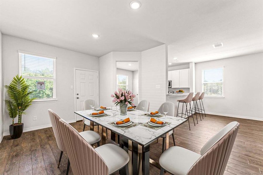 Dining room with dark wood finished floors and recessed lighting Dining room with dark wood finished floors and recessed lighting