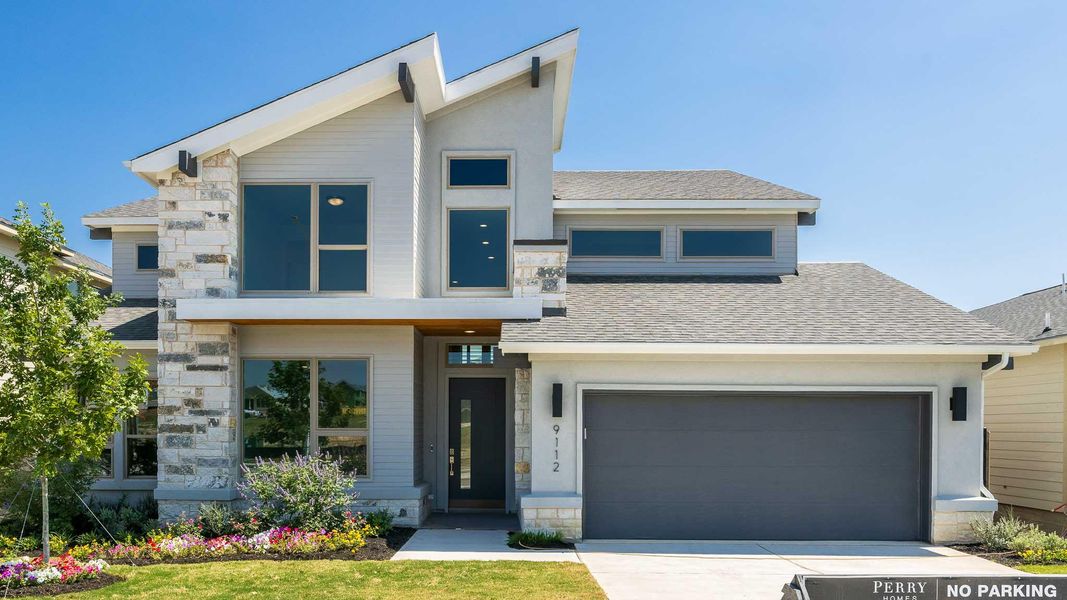 Modern home featuring stone siding, roof with shingles, concrete driveway, and a garage Modern home featuring stone siding, roof with shingles, concrete driveway, and a garage
