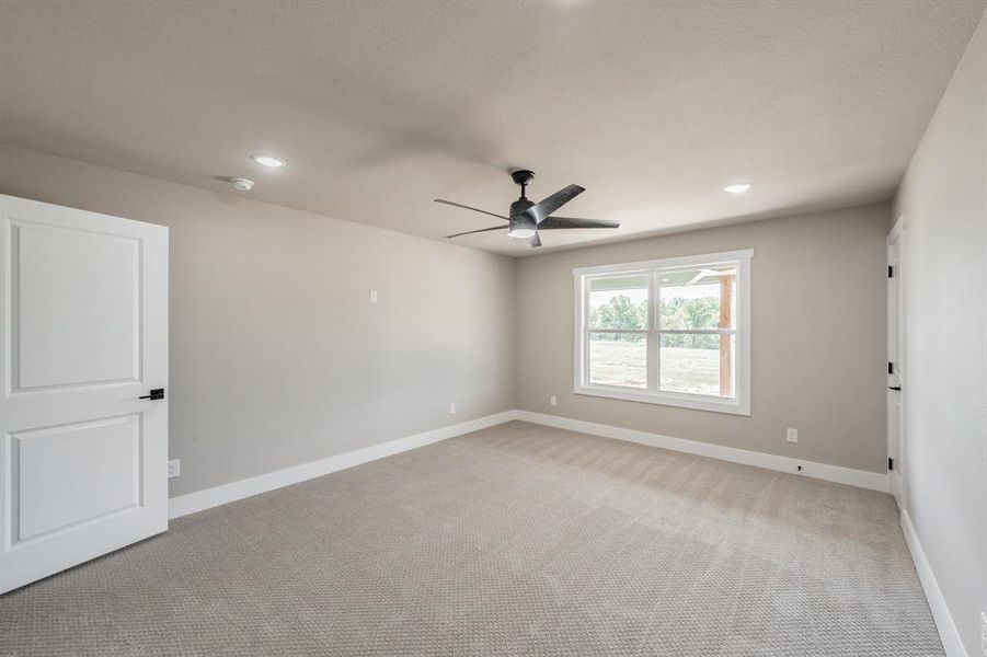 Empty room featuring light carpet, recessed lighting, and a ceiling fan Empty room featuring light carpet, recessed lighting, and a ceiling fan