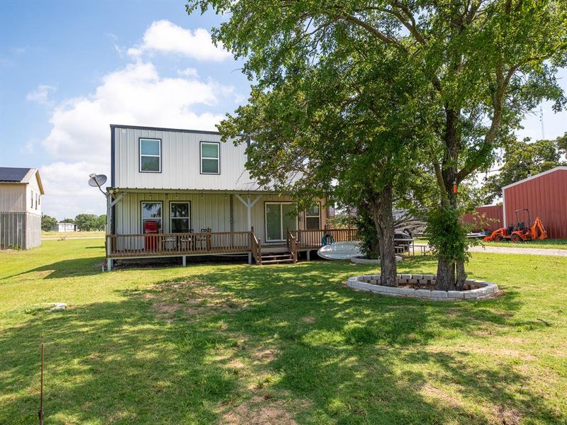 Extensive covered porch looking out at the private dock, boat ramp and lke frontage #lakefront #boatramp #dock #coveredporch #lakeleon #lakecabin