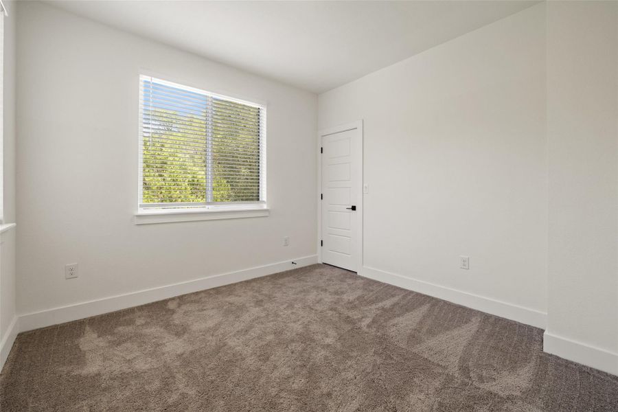 Carpeted spare room with baseboards Carpeted spare room with baseboards