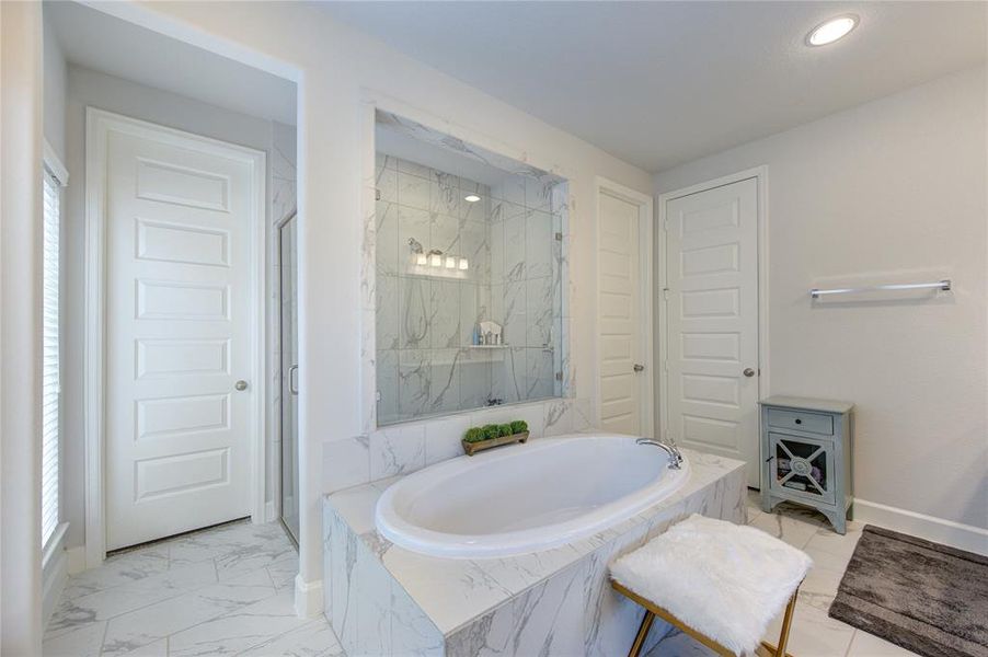 Escape to serenity: spacious primary bathroom with impressive shower.