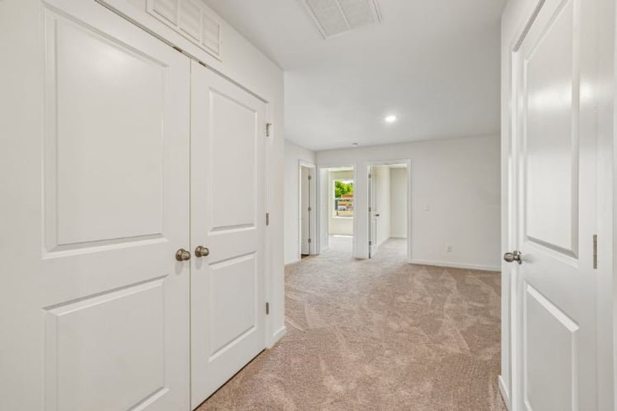 A hallway with white doors.