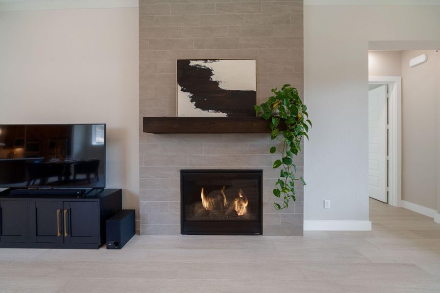 The modern stone fireplace with a wood mantel serves as the perfect focal point, adding warmth and charm. The modern stone fireplace with a wood mantel serves as the perfect focal point, adding warmth and charm.