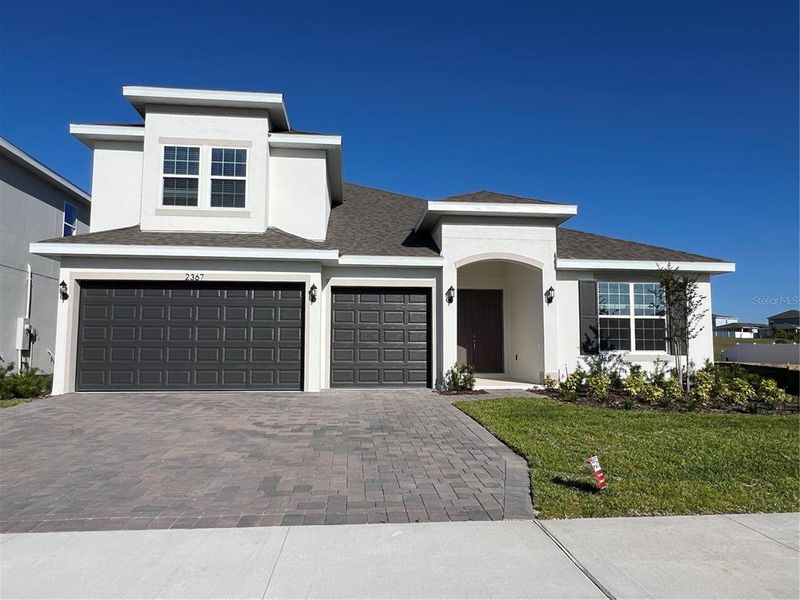 Front exterior of a new home in Hills of Minneola, Minneola, FL, highlighting curb appeal (Image 1). Front exterior of a new home in Hills of Minneola, Minneola, FL, highlighting curb appeal (Image 1).