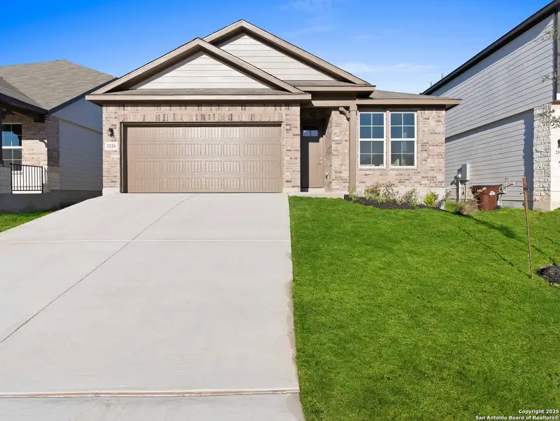 Front exterior of a new home in Hunter's Ranch, San Antonio, TX, highlighting curb appeal (Image 2). Front exterior of a new home in Hunter's Ranch, San Antonio, TX, highlighting curb appeal (Image 2).