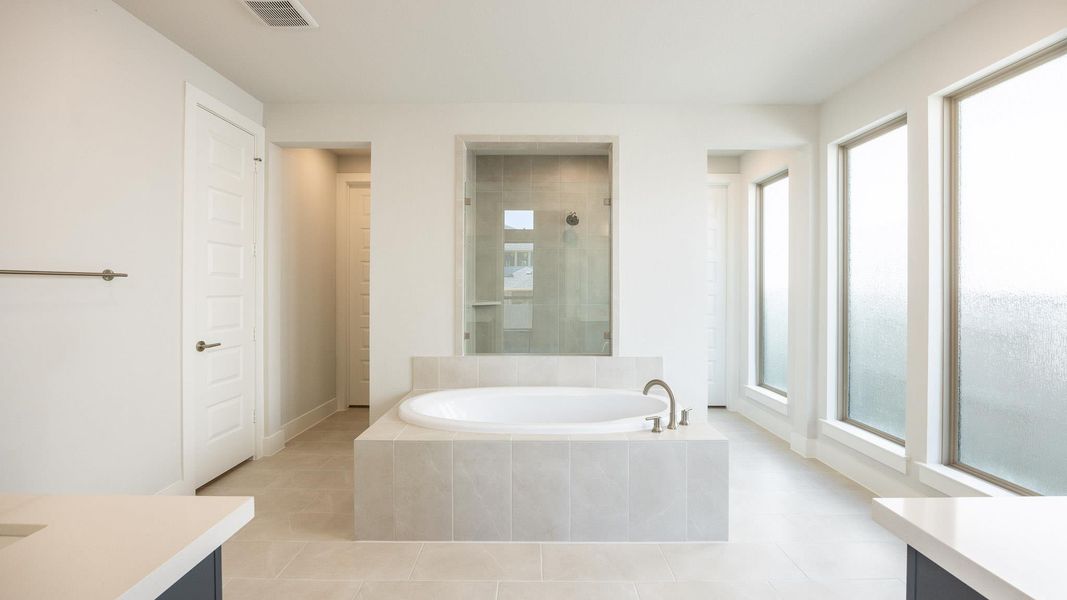 Full bathroom with vanity, a bath, tile patterned floors, and baseboards Full bathroom with vanity, a bath, tile patterned floors, and baseboards