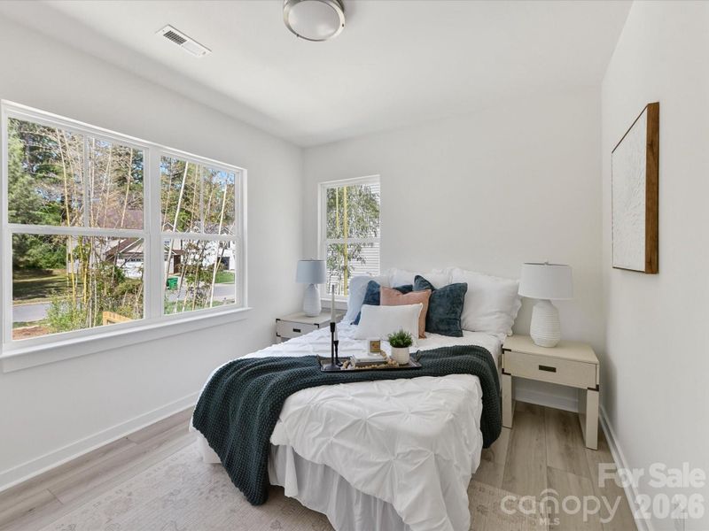 Bright and airy primary suite featuring a spacious bedroom, modern ensuite bathroom with sleek finishes, and a large walk-in closet for ample storage.