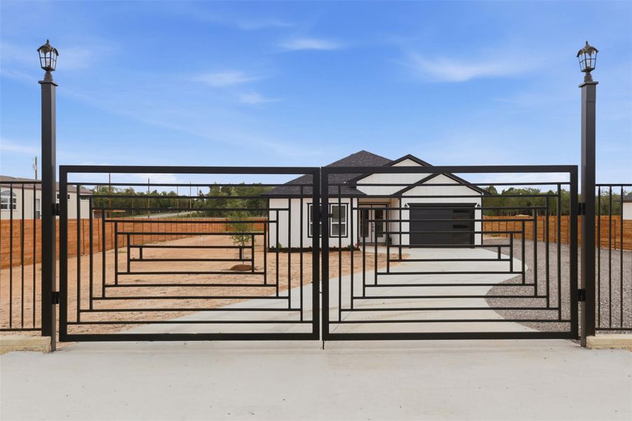 Wrought iron entry gate with decorative geometric pattern