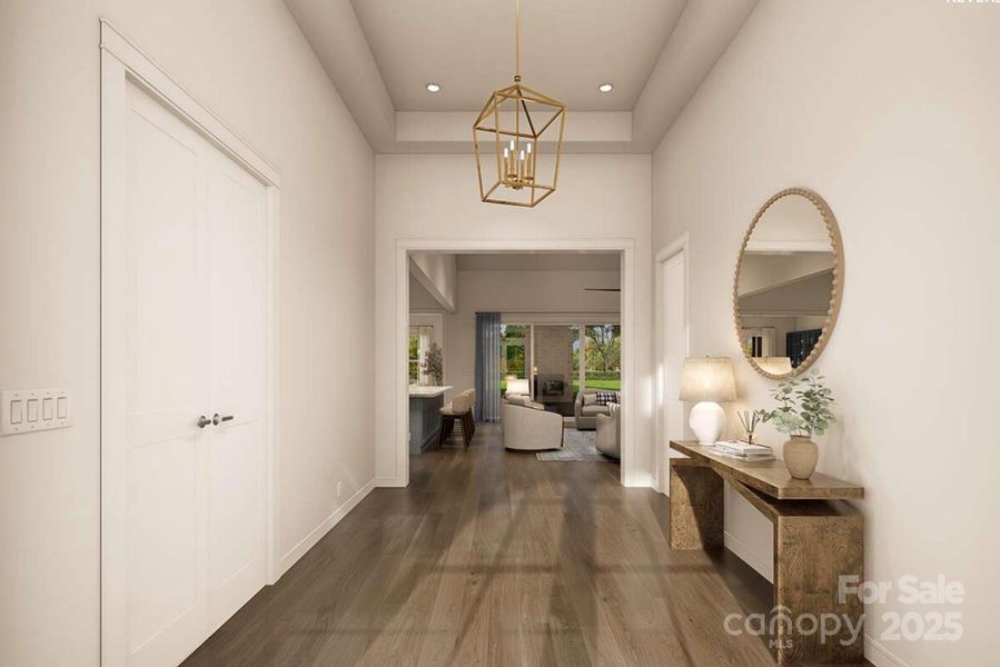 This elegant foyer sets a refined tone with its high tray ceiling, soft neutral palette, and sleek wood floors that flow seamlessly into the main living area. This elegant foyer sets a refined tone with its high tray ceiling, soft neutral palette, and sleek wood floors that flow seamlessly into the main living area.