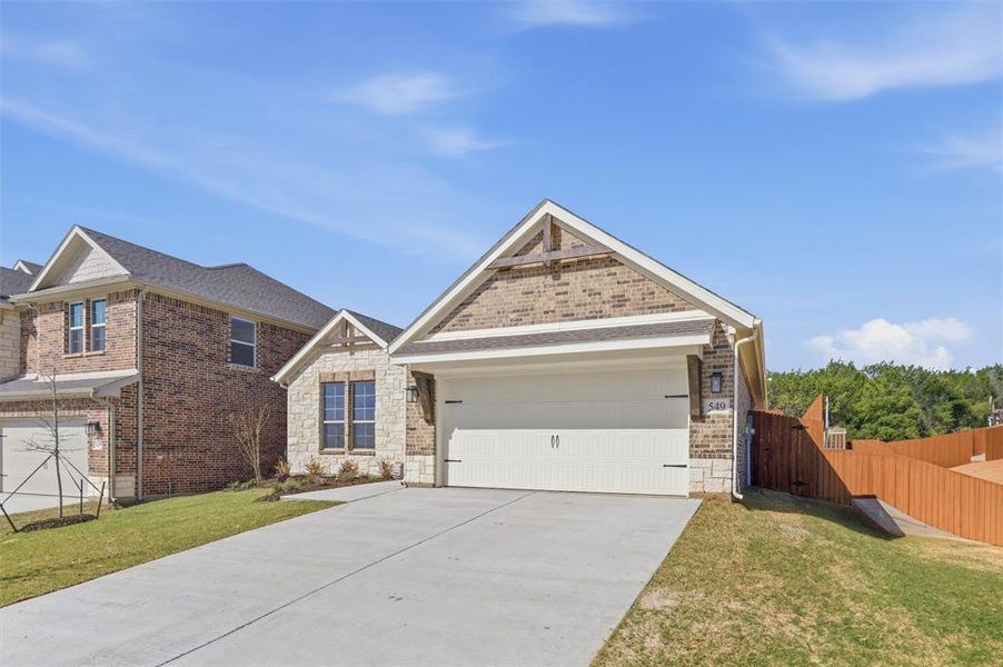 Craftsman house with driveway, brick siding, a garage, and stone siding
