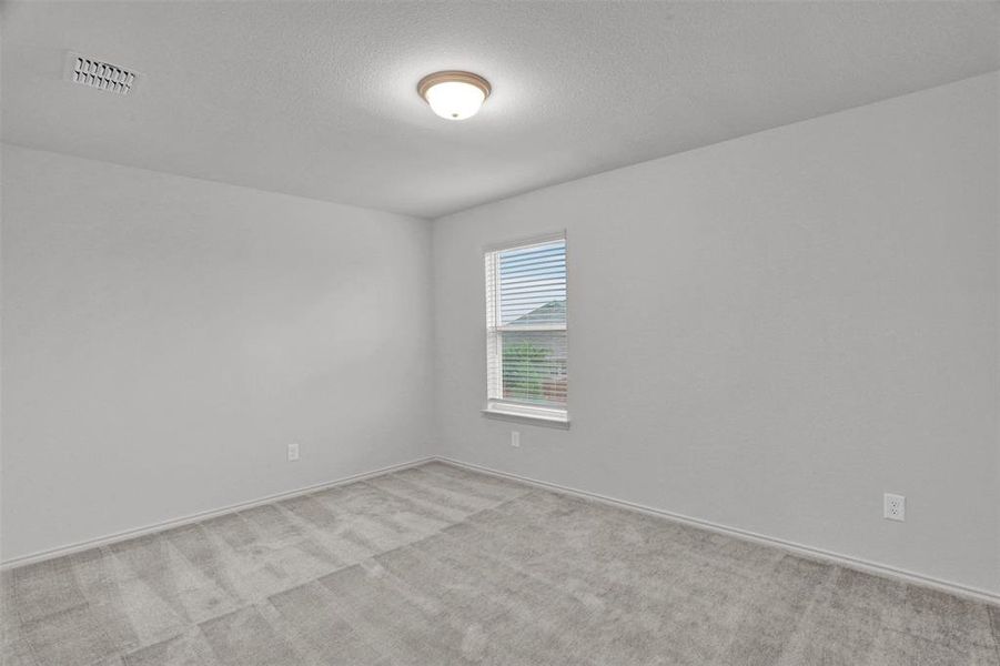Room featuring light gray carpeting, neutral-toned walls, and a single window with blinds