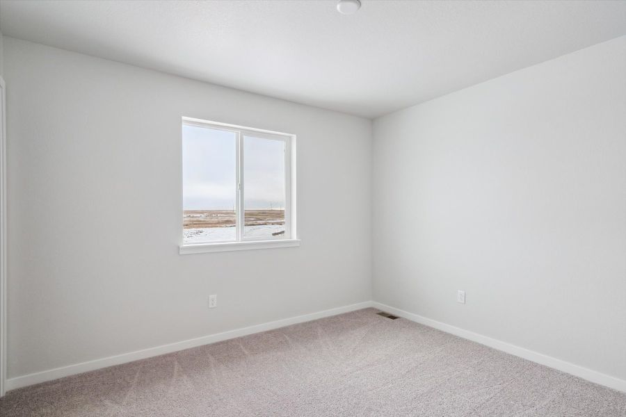 A room with a window and a carpet. A room with a window and a carpet.