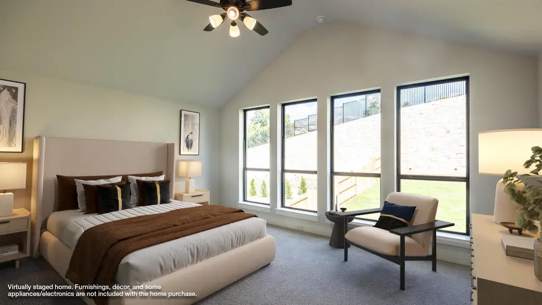 Bedroom with carpet flooring, vaulted ceiling, and ceiling fan Bedroom with carpet flooring, vaulted ceiling, and ceiling fan