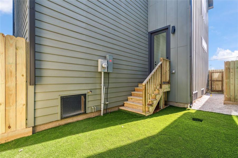 The backyard features artificial turf that is pet resistant and provide the ability to put outdoor furniture to create the oasis you want.