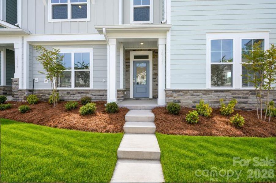 Exterior details and patio area of a home in North Creek Village - Townhomes, Huntersville (Image 3).