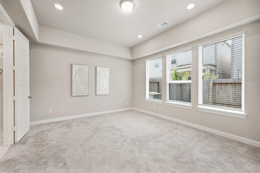 Primary Bedroom is enhanced by multiple windows that bring in natural light and give the room a bright, comfortable feel.