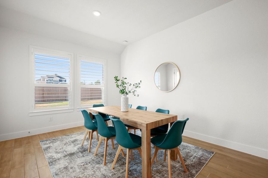 Dining space with light wood-style flooring and recessed lighting