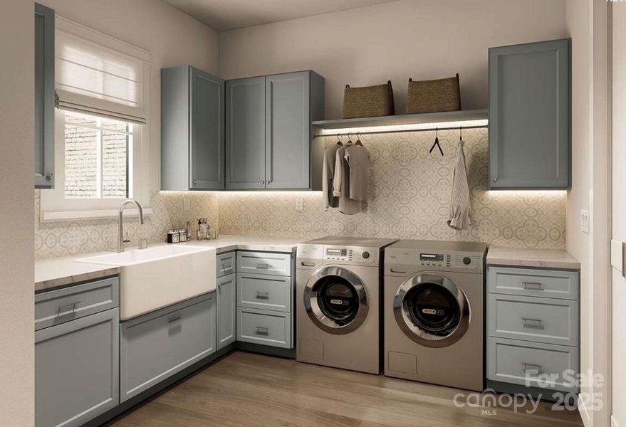 This beautifully appointed laundry room combines charm and utility with soft blue cabinetry, patterned backsplash tile, and warm wood flooring. This beautifully appointed laundry room combines charm and utility with soft blue cabinetry, patterned backsplash tile, and warm wood flooring.