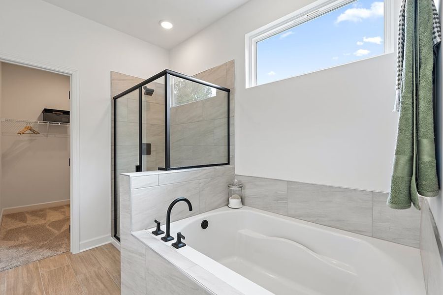 A bathroom with a tub and shower. A bathroom with a tub and shower.