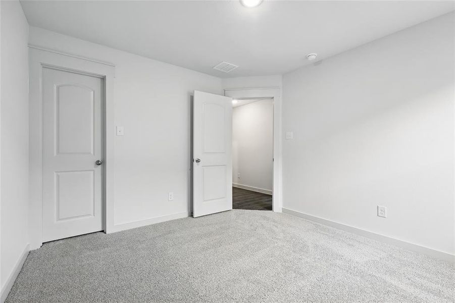Unfurnished bedroom featuring carpet floors and baseboards Unfurnished bedroom featuring carpet floors and baseboards