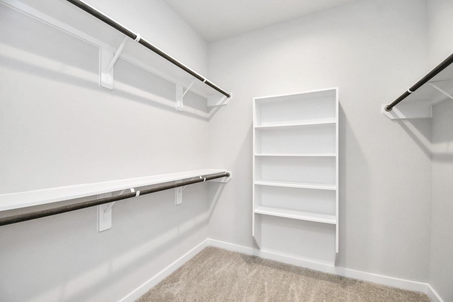 Walk-in closet that epitomizes luxury and practicality. This generously sized space features built-in shelving, offering abundant room for impeccable organization. High ceilings and recessed lighting create a bright and welcoming ambiance. Walk-in closet that epitomizes luxury and practicality. This generously sized space features built-in shelving, offering abundant room for impeccable organization. High ceilings and recessed lighting create a bright and welcoming ambiance.