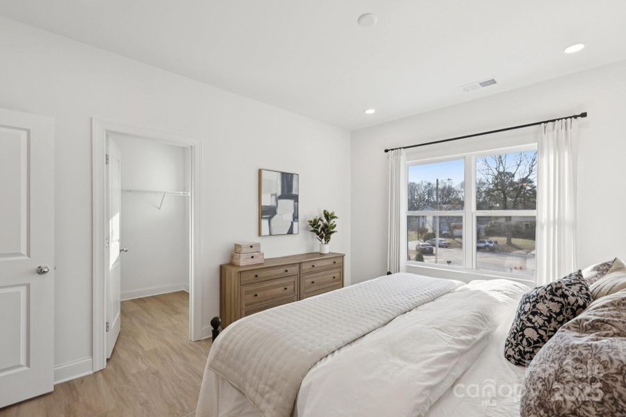 Large primary suite with massive walk-in closet and en suite bathroom with tiled shower wall