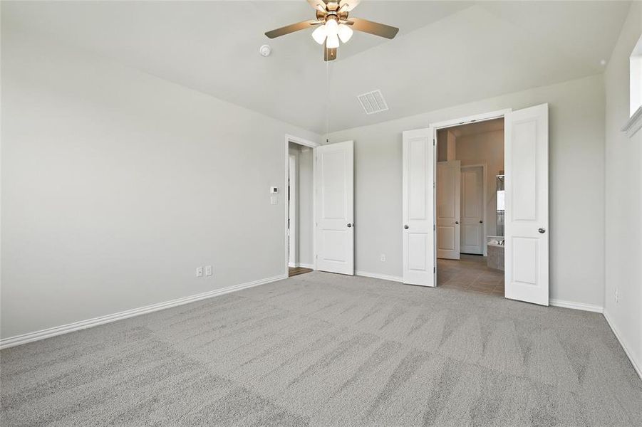 Unfurnished bedroom featuring carpet floors, lofted ceiling, and connected bathroom Unfurnished bedroom featuring carpet floors, lofted ceiling, and connected bathroom