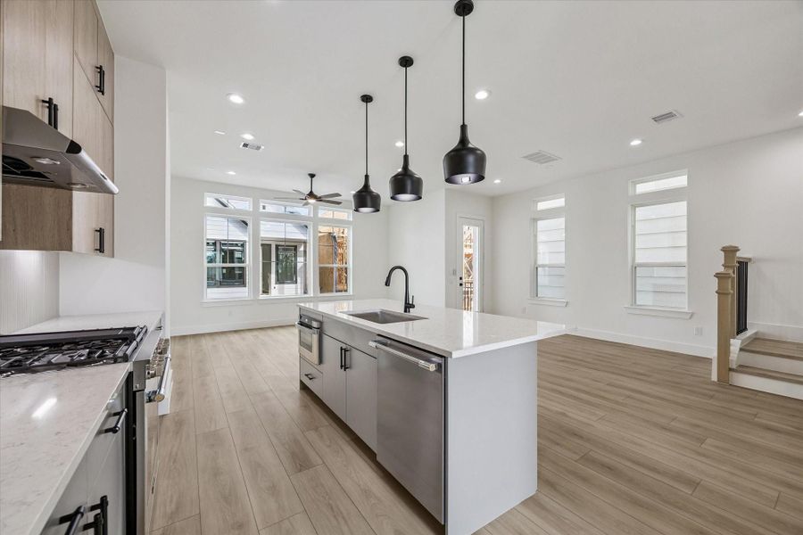 Beautiful kitchen with oversized island, pendant lighting, and open sightlines Beautiful kitchen with oversized island, pendant lighting, and open sightlines