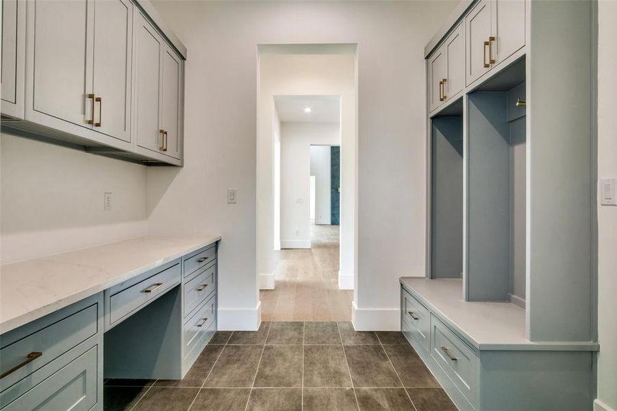 Mudroom with baseboards and dark tile patterned floors