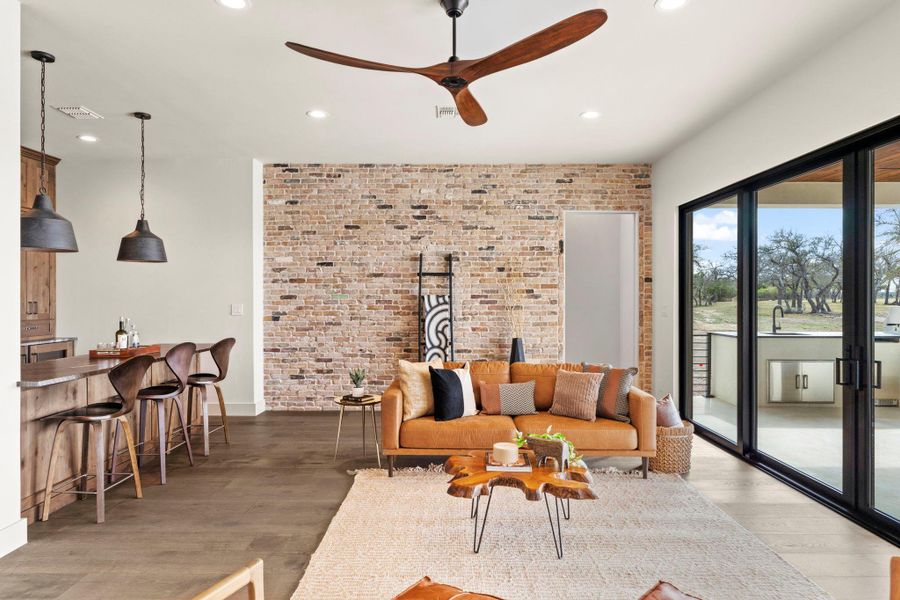 Brick wall in media area opening to outdoor living.