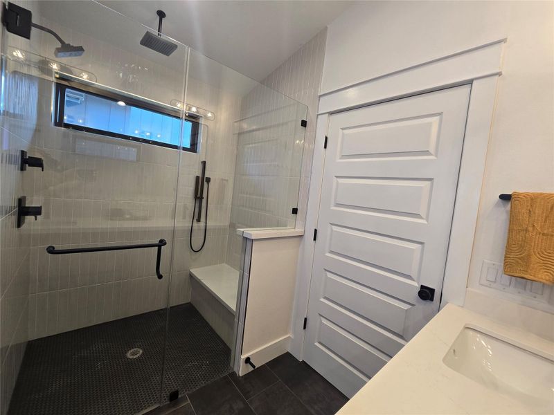 Clean lines and a glass-enclosed shower highlight this modern bathroom space.