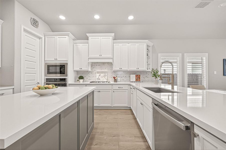 Ample cabinetry, quartz countertops, stainless steel appliances, and a spacious center island— this kitchen is truly the heart of the home. (Note: Photo is staged; property is currently vacant.) Ample cabinetry, quartz countertops, stainless steel appliances, and a spacious center island— this kitchen is truly the heart of the home. (Note: Photo is staged; property is currently vacant.)