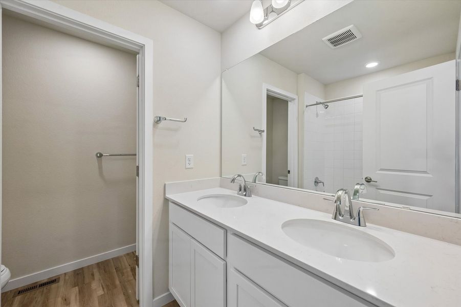 A bathroom with a large mirror.