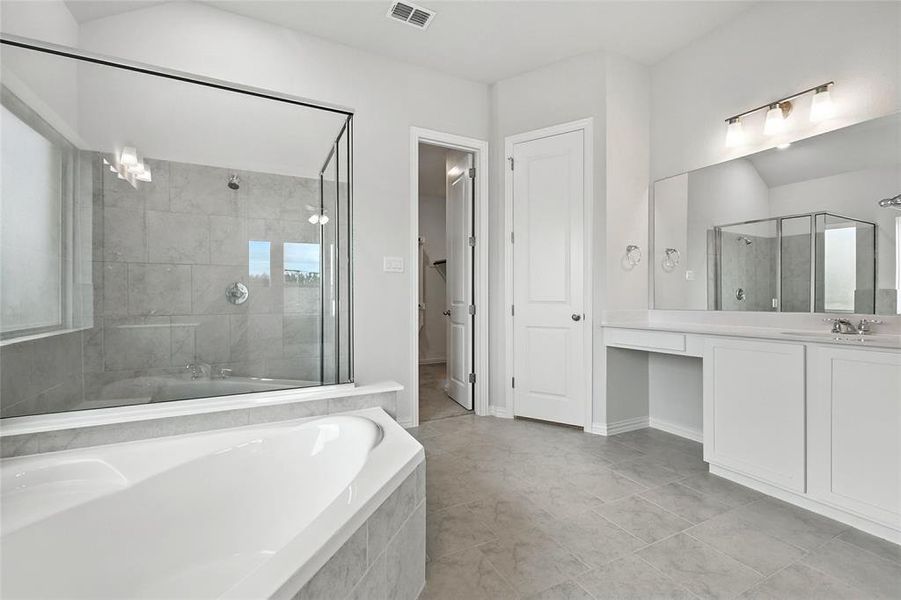 Full bath with a garden tub, a stall shower, and vanity Full bath with a garden tub, a stall shower, and vanity