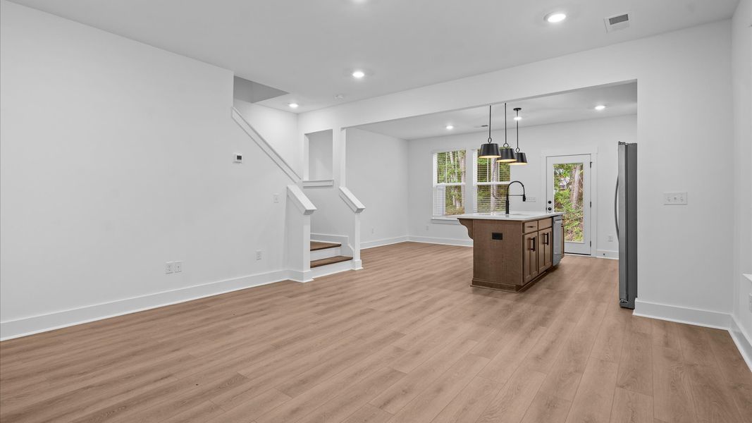 Elegant family room with hardwood flooring and open-concept flow in this first-class DRB Homes design Elegant family room with hardwood flooring and open-concept flow in this first-class DRB Homes design