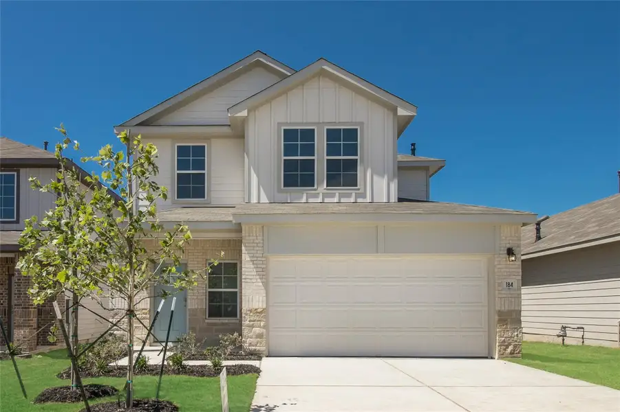 Front exterior of a new home in Prairie Lakes, Buda, TX, highlighting curb appeal (Image 2). Front exterior of a new home in Prairie Lakes, Buda, TX, highlighting curb appeal (Image 2).